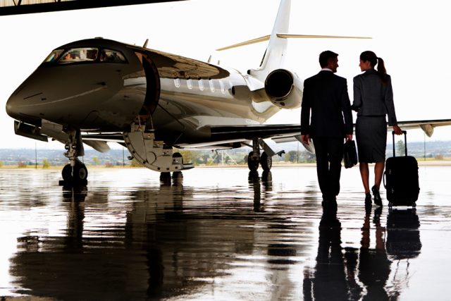 Two executives walking to private jet